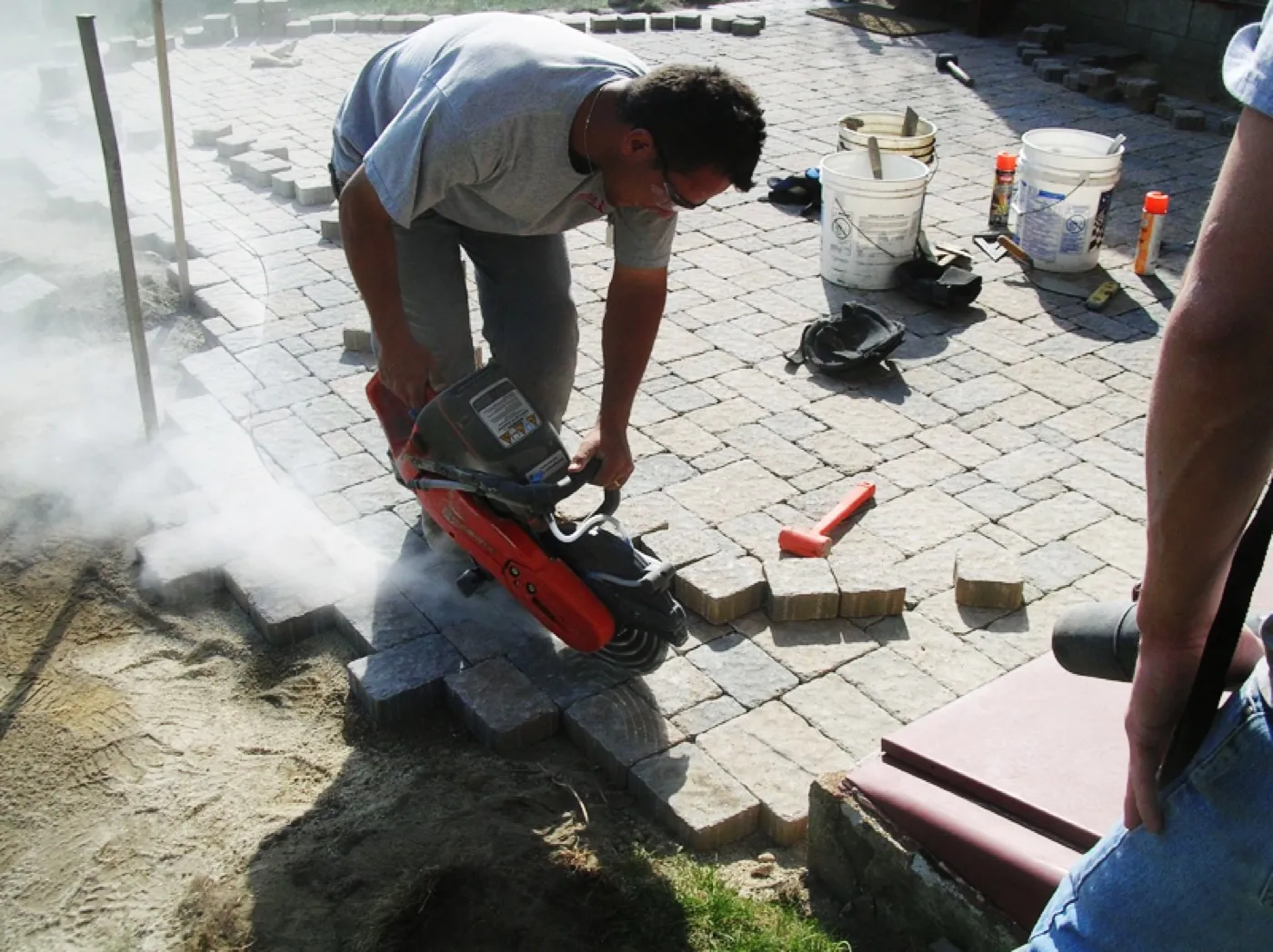 A Tamarack mason cutting stone by hand